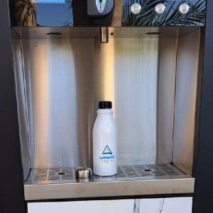 Water dispenser with white bottle, clean and modern ambiance.